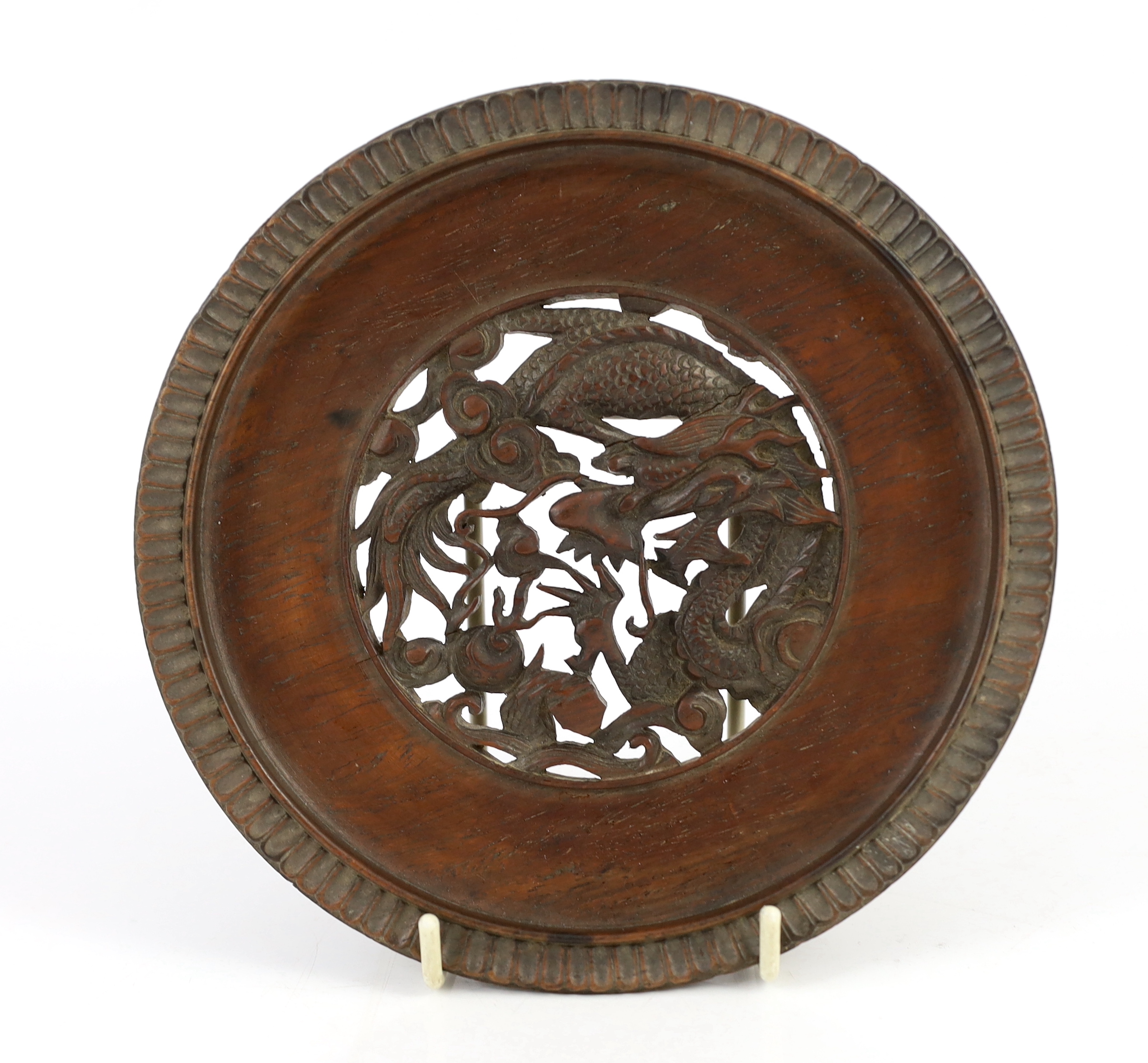 A Chinese carved wood ‘lotus’ stand and a Chinese huanghuali ‘dragon’ stand, Qing dynasty